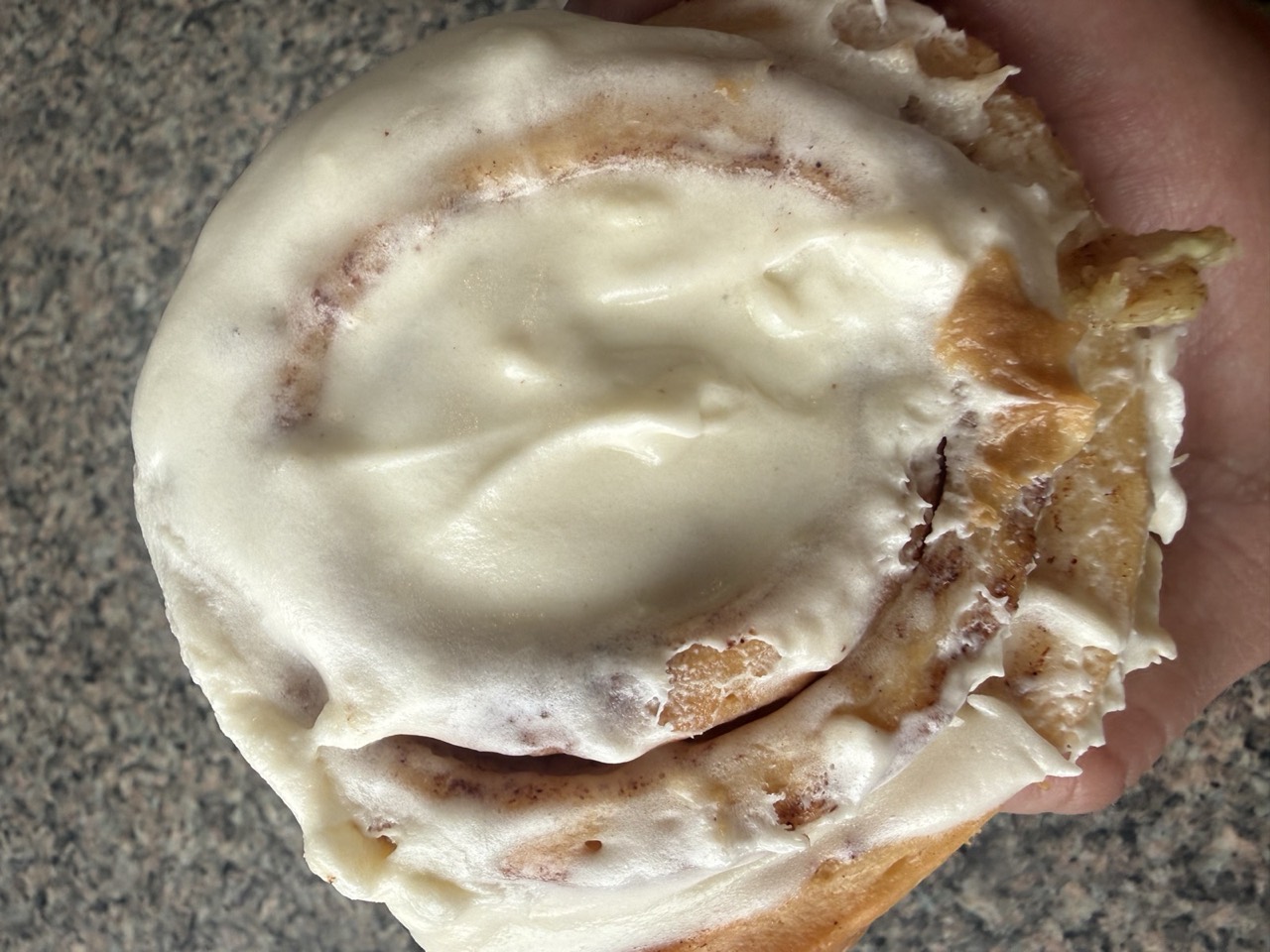 Classic Glaze roll with cream frosting, fresh out of the oven